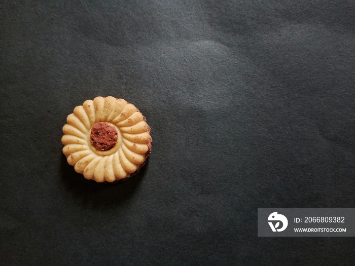 Chocolate jam biscuit on black background