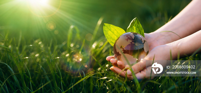 Hand holding crystal earth globe.  Earth Day. Environment day, save clean planet, ecology concept.