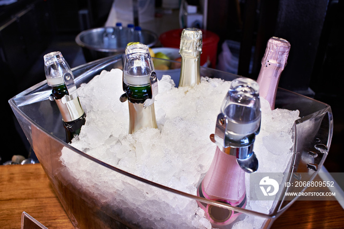 Champagne on ice in glass plate