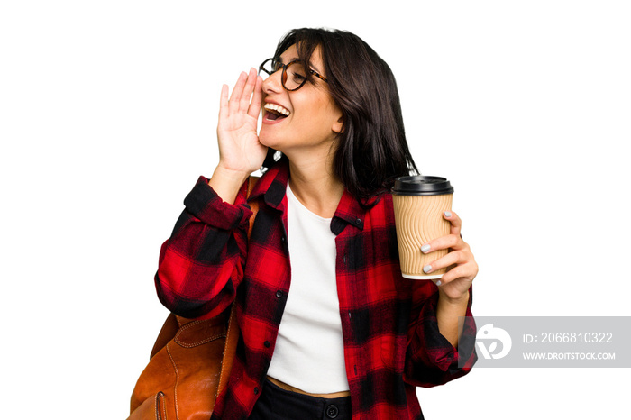 Young student Indian woman holding a take away coffee isolated shouting and holding palm near opened mouth.