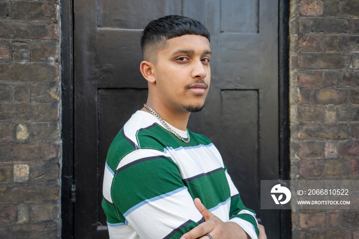 Portrait of young man wearing striped sweatshirt