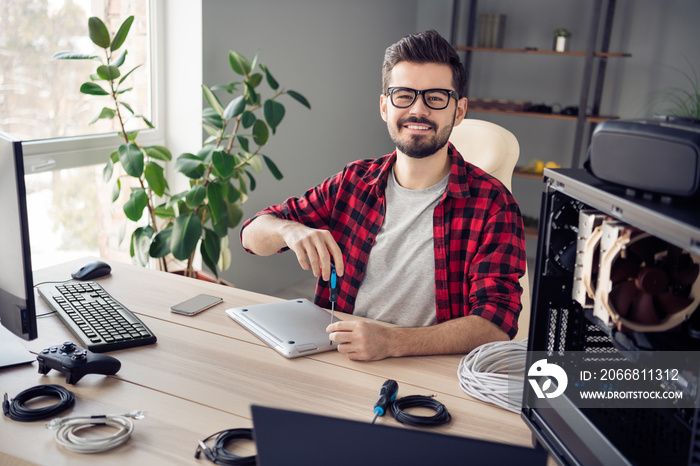 Portrait of attractive experienced trendy cheerful guy repairing device career success process at office work place station indoor