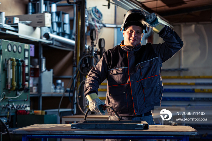 Portrait of a smiling welder posing in the factory