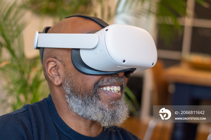 Mature man wearing VR headset