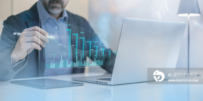 Businessman calculating ROI with laptop. Return of investment, increase of value, dividend concept.