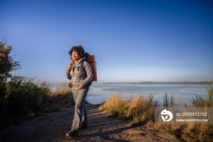 U.S. Army female soldier putting in the miles with an early morning hike in the NorthWest.