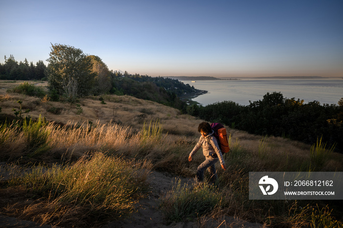 U.S. Army female soldier putting in the miles with an early morning hike in the NorthWest.