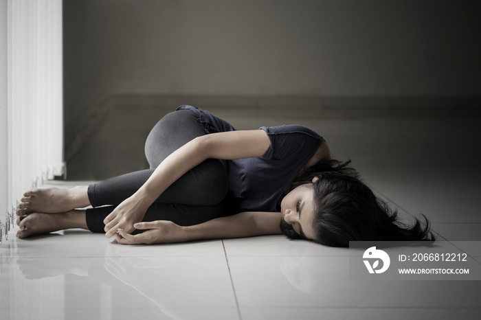 Skinny woman lying on the floor