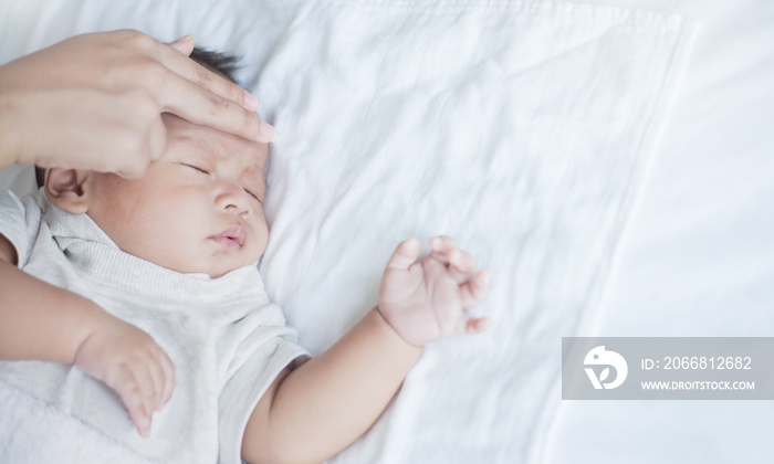 Mother Checks The Temperature Of A Sick Baby, newborn baby had a fever. Healthcare medical concept