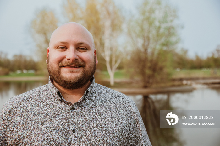 closeup of plus size bald man looking at camera