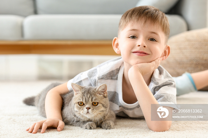 Little boy with cute cat at home