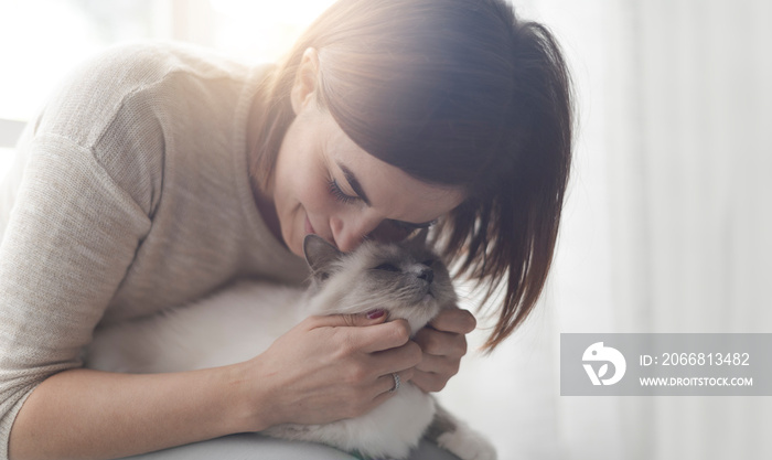 Woman hugging and petting her cat