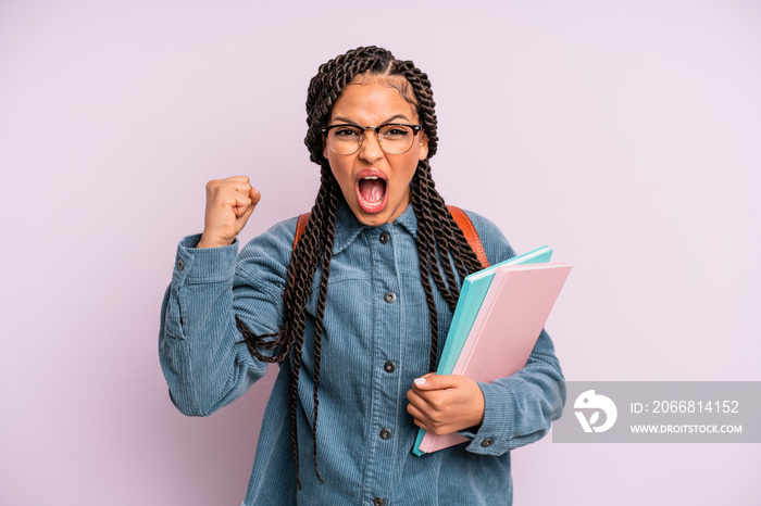 black afro woman shouting aggressively with an angry expression. university student concept