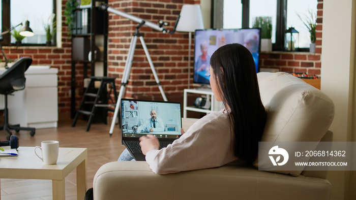 Patient getting online consultation through telehealth platform while talking with general practitioner on online videocall on laptop. Woman discussing with physician doctor on remote call.