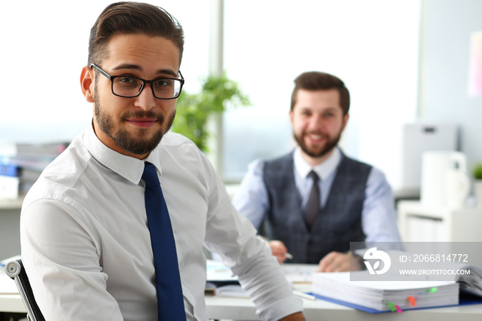 Group of smiling bearded businessmen in suit and tie