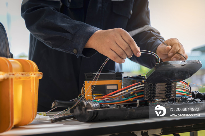 Engineer is inspecting connecting fiber optic and optical distribution frame with splicing machine..