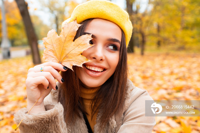 Autumn woman in autumn park. Warm sunny weather. Fall concept.A beautiful female dreaming in the autumn park.