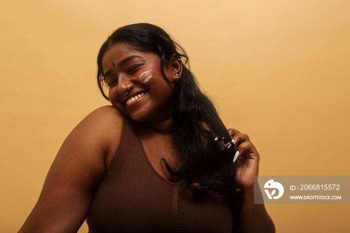 South Asian female solo lifestyle studio portrait skin care shot