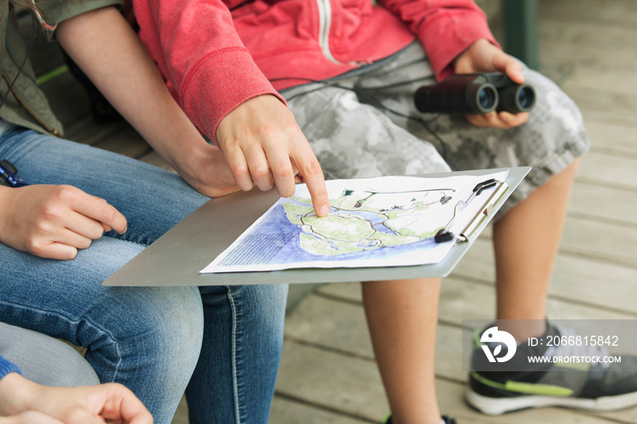 middle school students reviewing field trip map