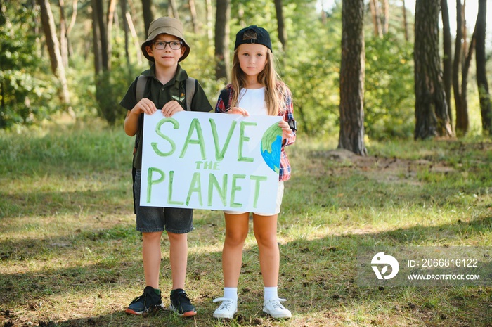 Children are holding a poster: Save the planet. Earth Day. Let’s save the planet from pollution.