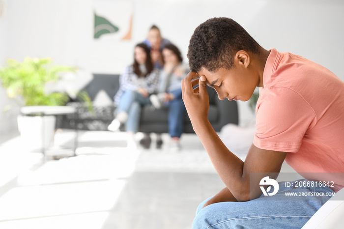 Lonely African-American teenage boy in room. Stop racism