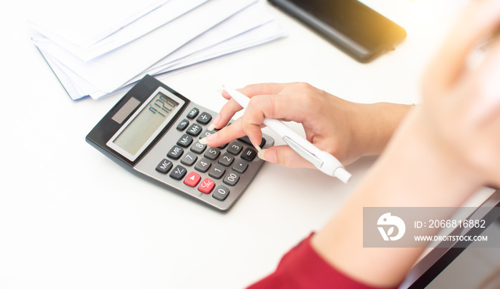 Hand of woman is using calculator