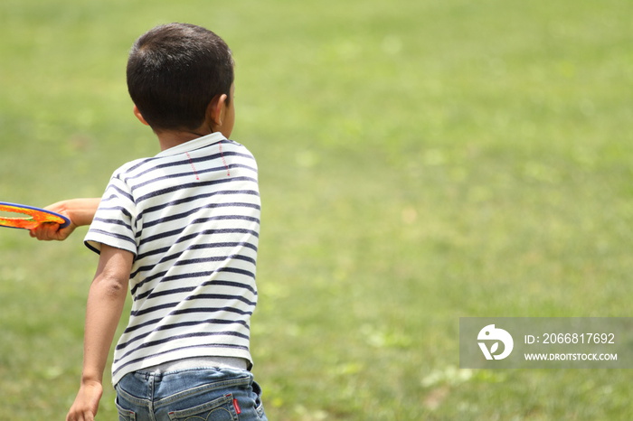 Japanese boy playing flying disc (first grade at elementary school)