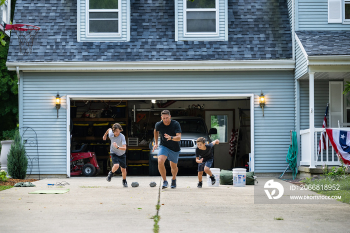 Air Force service member trains with his sons in a morning workout in preperation for a PT fitness test.