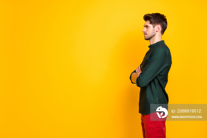 Profile side photo of confident cool serious guy entrepreneur listen solve work start-up problems cross hands look wear casual style outfit red pants trousers isolated over yellow color background