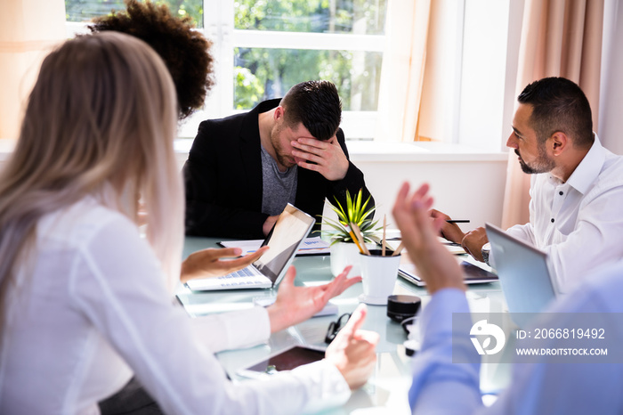 Businesspeople Blaming Their Colleague In Office