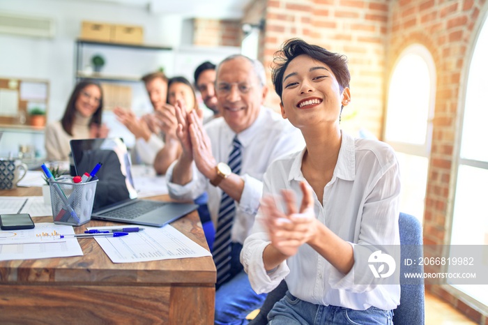 Group of business workers smiling happy and confident. Working together with smile on face looking at the camera applauding at the office