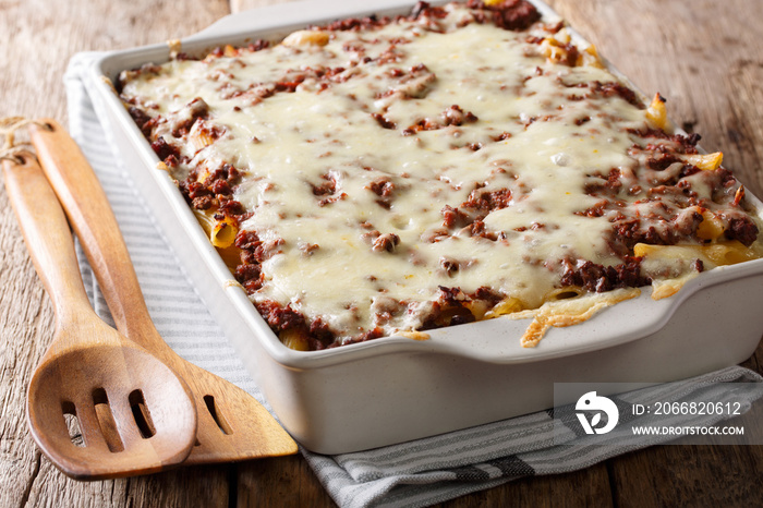 Million dollars pasta casserole with beef meat and cheese in a baking dish close-up. Horizontal