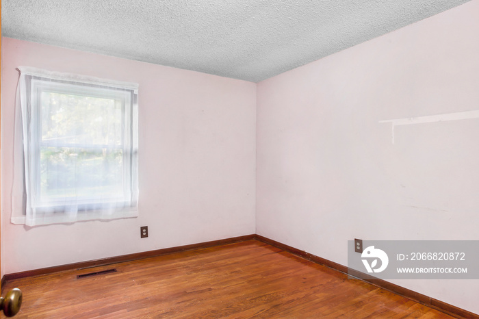 fixer upper bedroom with hardwood floors and pink walls