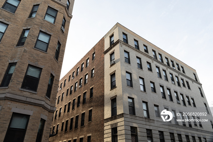 Very generic urban brick apartment buildings with rowns of windows, urban cityscape, horizontal aspect