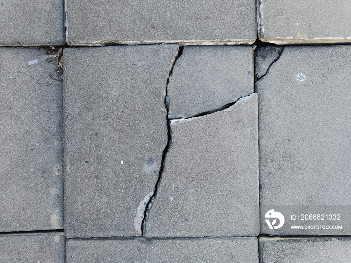 The pedestrian walkway was built of cracked bricks, not well built.