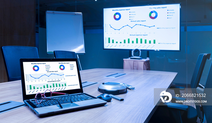 Laptop and television with presentation slideshow in meeting room