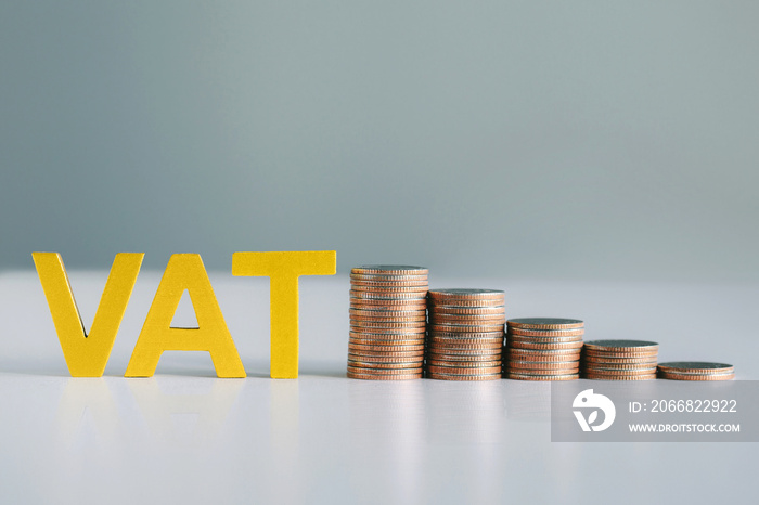 Vat Concept.Word vat and  stacked coins on white table