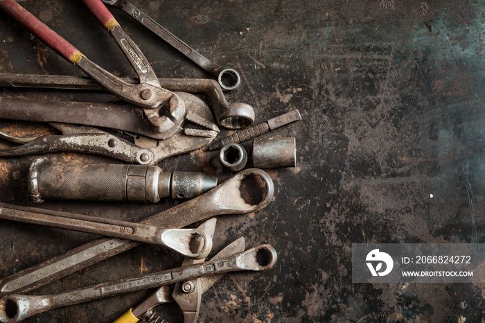 Flat lay Old hand tools ,Pliers screwdriver wrench rusted iron metal tools on Steel plate at garage