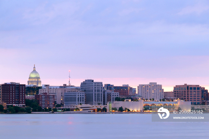 Downtown skyline of Madison, the capital city of Wisconsin, USA. After sunset view with State Capitol building dome against beautiful colored sky from Olin Park.