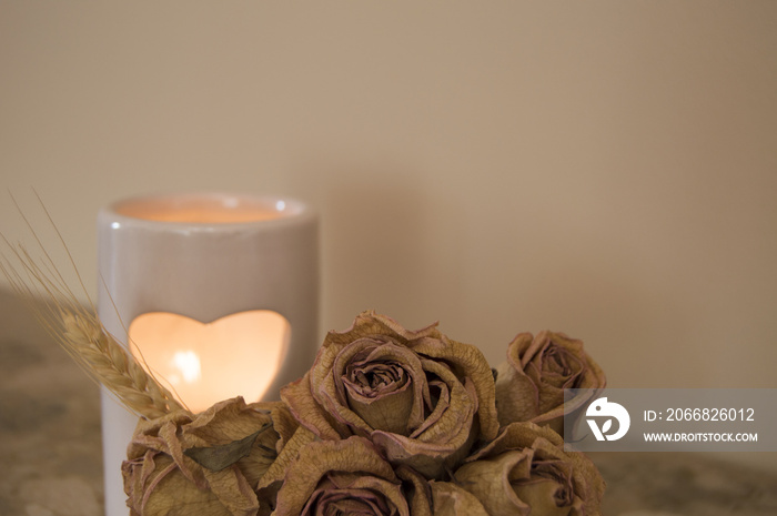 Aromatherapy candle and dried roses. Love hearth candle. Living room decor.