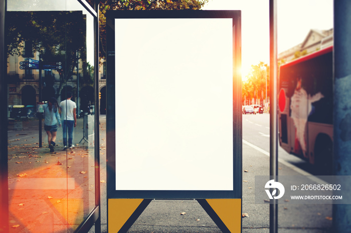 Blank billboard with copy space area for your text message or promotional content, public information board in urban setting, metropolitan city bus stop with empty mock up banner for your advertising