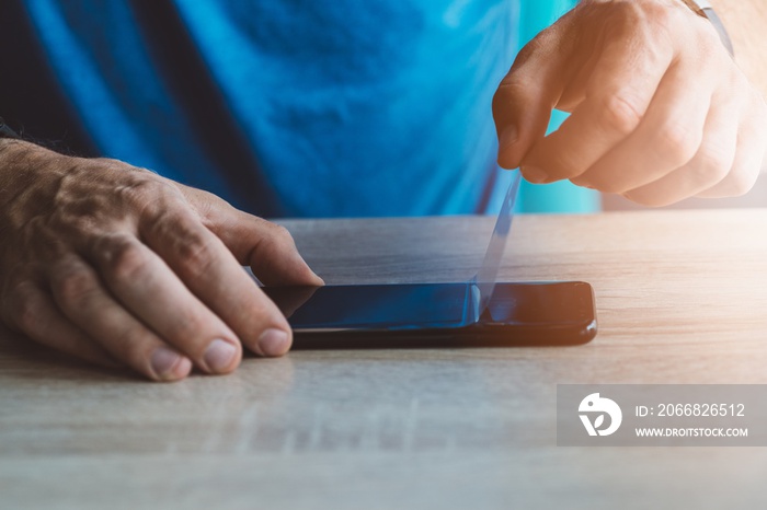 Man applying protective screen protector