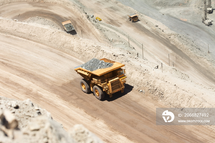 Huge dump trucks loaded with mineral  in a copper mine in Chile.