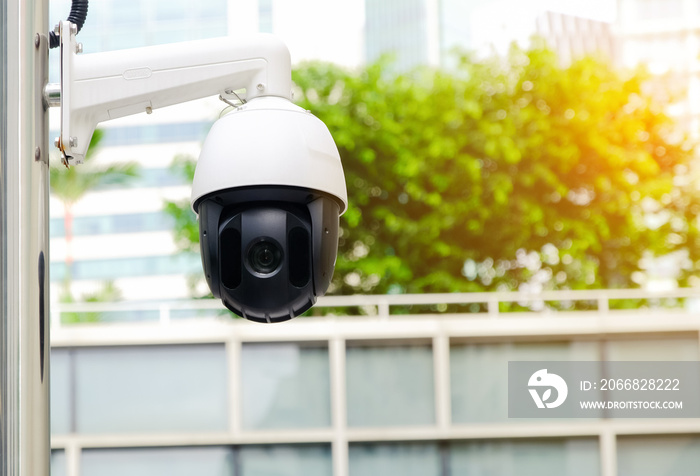 Modern public CCTV camera on electric pole with blur building background. Recording cameras for monitoring all day and night. Concept of surveillance and monitoring with copy space.