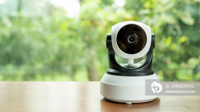 The security IP camera on a wooden table.