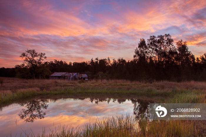 Beautiful sunset over Teds Hut and dam .Sedgefield near Singleton. Hunter Valley of  N.S.W. Australia.