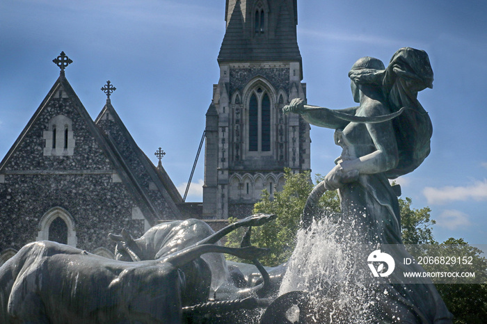 Copenhagen, Denmark - St. Alban’s English Church in Gothic Revival style and goddess Gefion fountain from 1908,the largest monument in Copenhagen