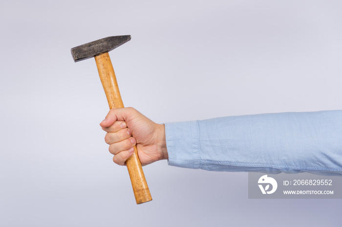 Male hand holding hammer on white background. Claw hammer Side view.