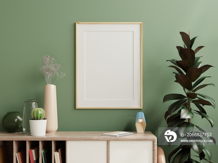 Mockup photo frame green wall mounted on the wooden cabinet with beautiful plants.