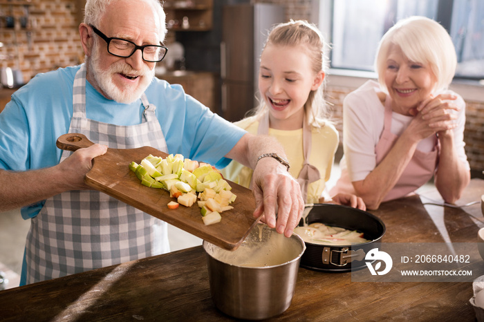 grandparents and girl cooking together